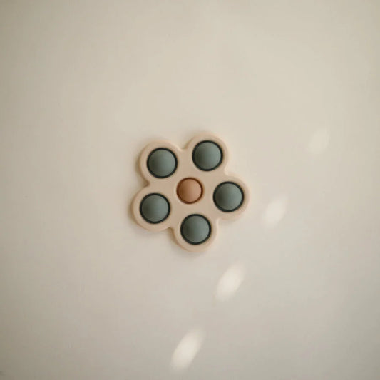 Blume Plop-it Spielzeug mit orangener und grüner Knopf-Anordnung für Kinder