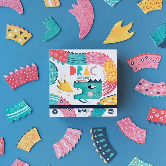 Bunte Spieleschachtel Drac Game mit Cartoon-Drache und verschiedenen Körperteilen