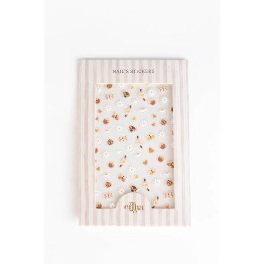 Elfa 3D-Nageltattoos für Kinder mit Blumenmotiv und Goldakzenten auf weißem Hintergrund
