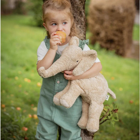 Child holding the soft beige Senger Naturwelt Large Plush Elephant in Linen