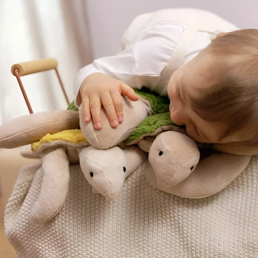 Child resting on Senger Naturwelt Small turtle cuddly toys in Fir Green