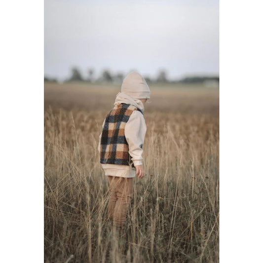 Plaid Vest and Cream Hoodie Outfit in Tall Grass with Loose Fit Pants from Kakao