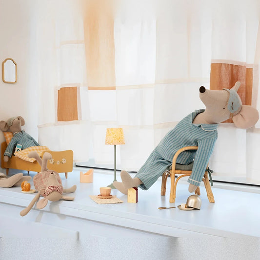 Plush mouse in pyjamas relaxing in a wooden chair. Maxi-Mouse in Pyjamas