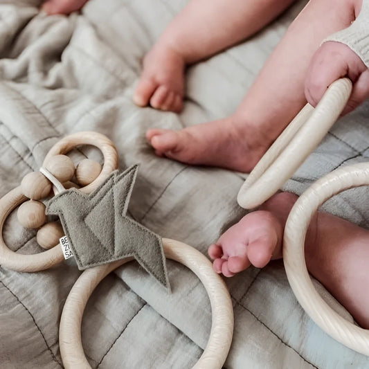 Holz-Beißring mit geometrischen Formen und Ringen in Pistache Grün von Rassel Vogel