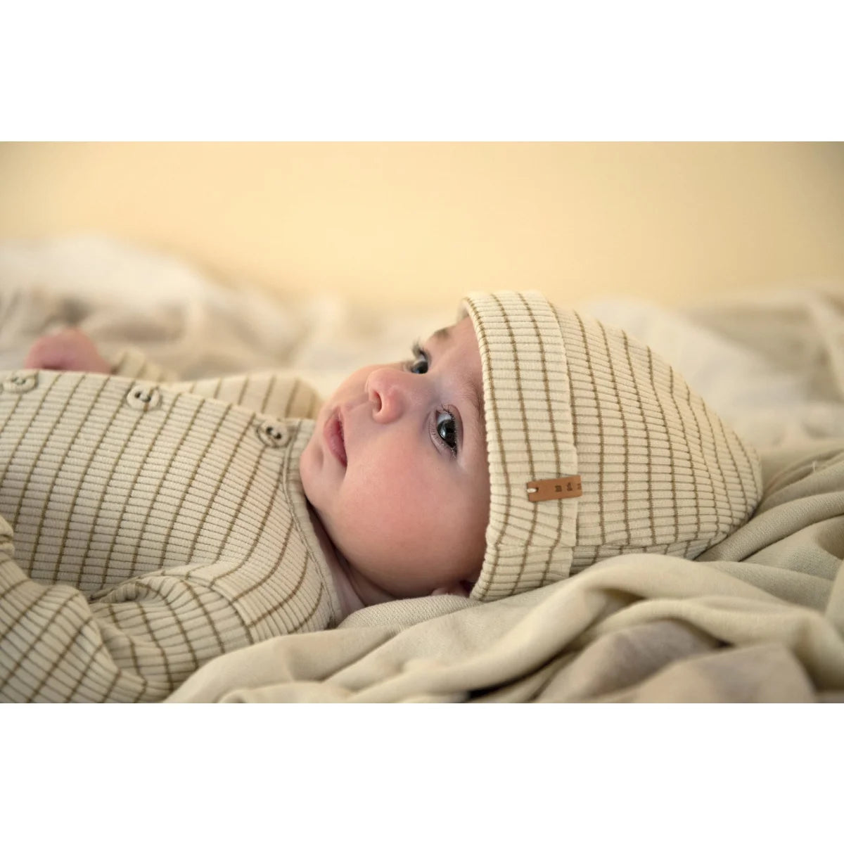 Baby in biscuit stripe Rib Onesie with matching striped hat