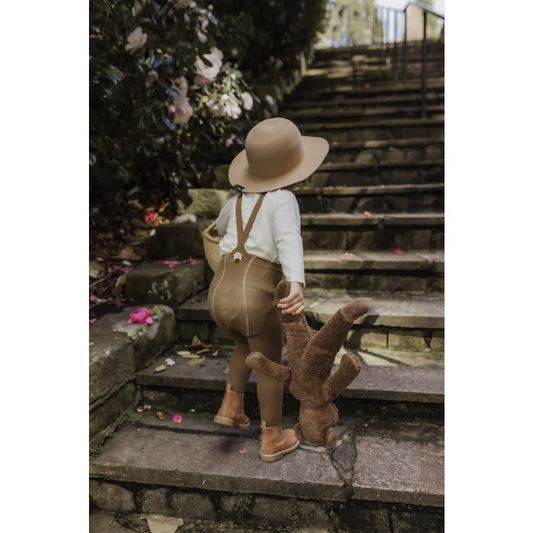 Kind, das Treppen mit einem Teddybär klettert, trägt Strumpfhose mit Träger in Acorn Brown