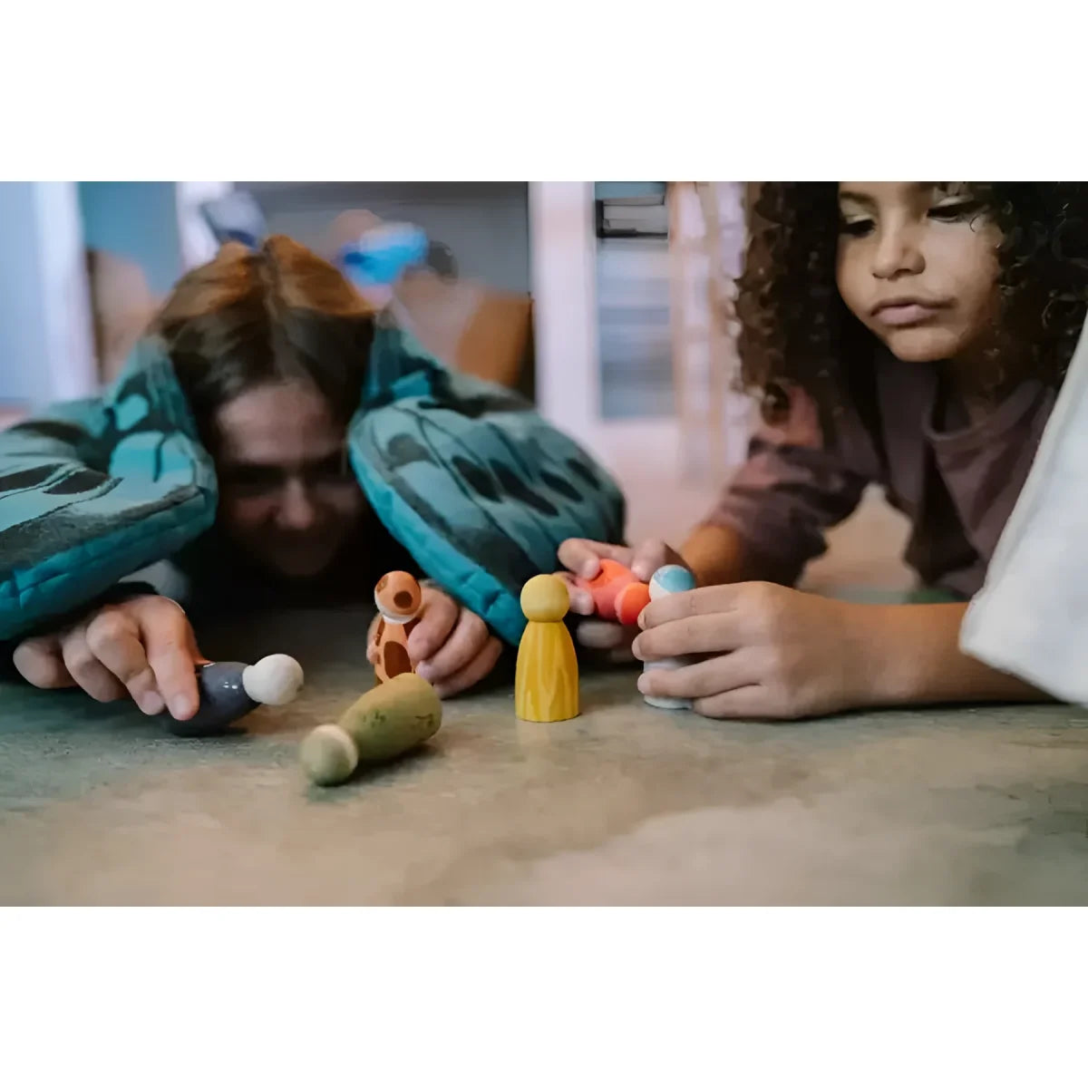 Wooden toy figures with painted faces and colorful bodies from the animal crew collection