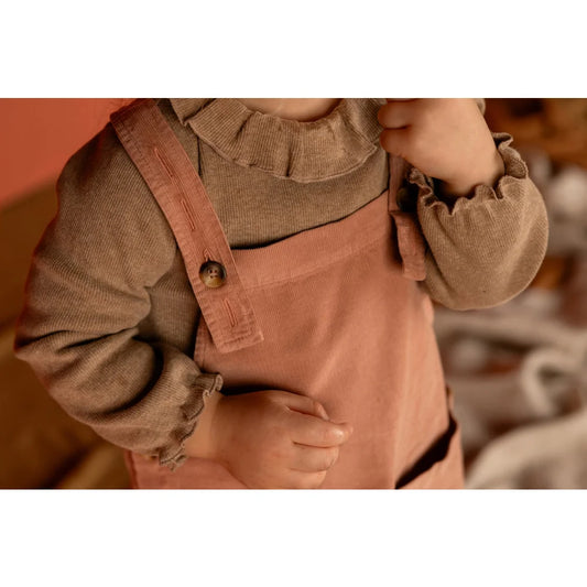 Pink corduroy overalls for children with ruffled-neck top by Tuc Longsleeve in pebble