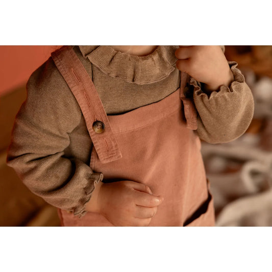 Pink corduroy overalls for children with ruffled-neck top by Tuc Longsleeve in pebble
