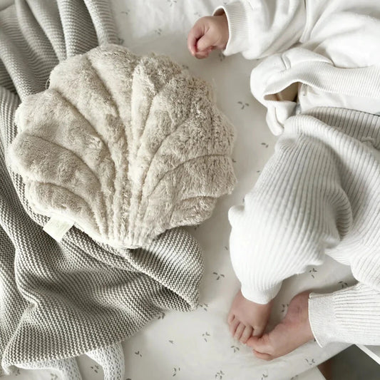Beige shell-shaped small shell heat pad for relaxation and comfort