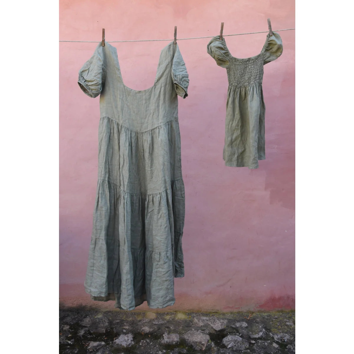 Zwei grüne Kleider an einer Wäscheleine, Teil des Wildflower Kleid Sage Produkts
