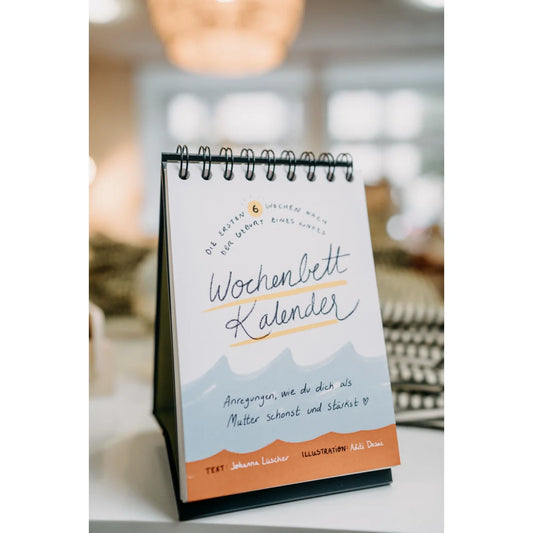 Bunter Wochenbettkalender mit Drahtbindung und buntem Cover, perfekt für Babyzeit