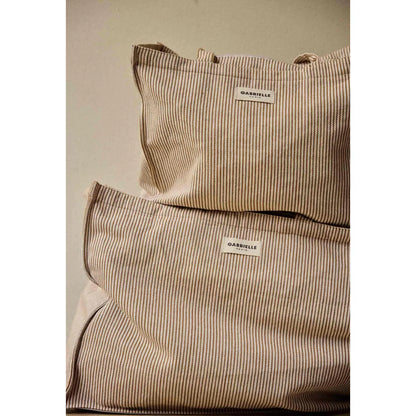 Beige und schwarze canvas-tasche mit vertikalen streifen und gabrielle paris label ideal für ökologische baby- & kinderprodukte