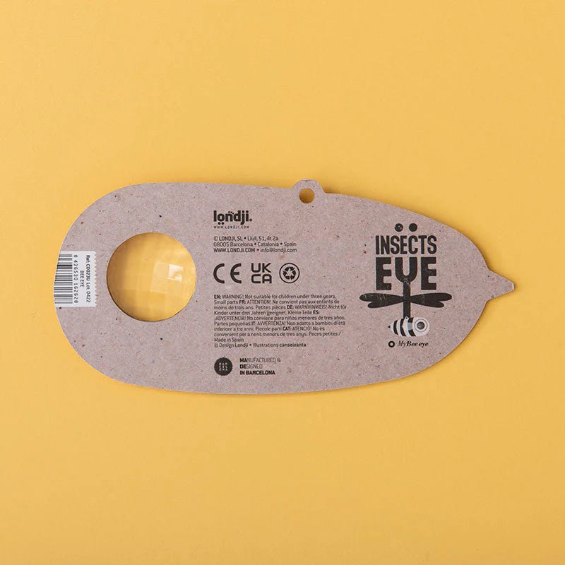 Graues Insekt-Auge-Spielzeug aus recyceltem Karton mit gelber Linse und Libellendesign