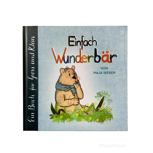 Bilderbuchcover mit einem braunen Bären im blauen Schal im Gras sitzend