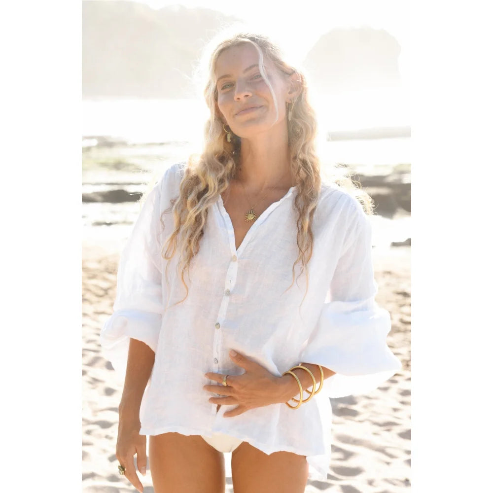 Frau mit langen Locken, weißes Leinenhemd, Bikini, Goldschmuck, Bluse Lily Blanco