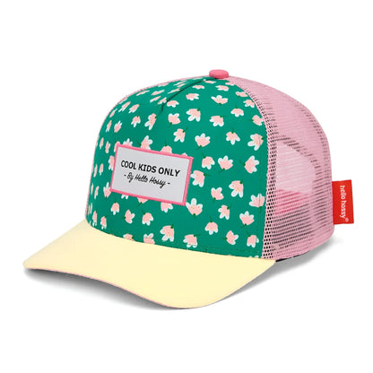 A vibrant green and pink floral-patterned trucker hat with pale yellow brim featuring cool kids only label by Hello Kitty