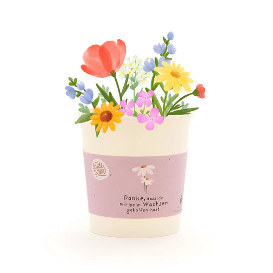 Danke wachsen becher in pastellpink und creme mit floraler illustration aus ökologischem material für geschenke für neugeborene