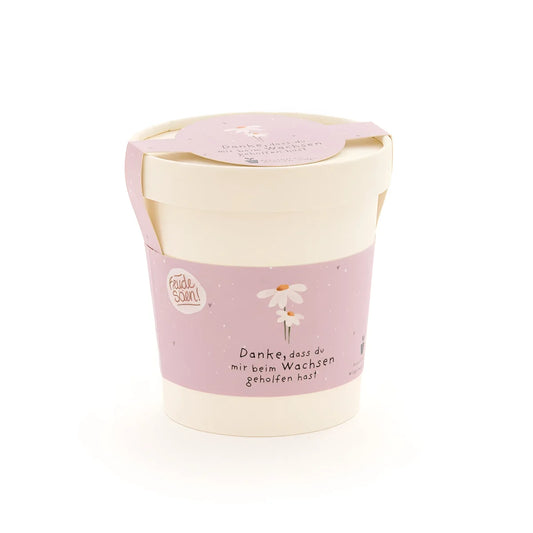 Weicher pink-cremefarbener danke wachsen becher mit zarter gänseblümchen-illustration als ökologische baby- & kinderprodukte geschenkidee