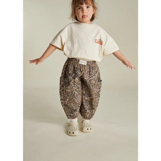 Kind bei Trage der Emerson Trouser Leo in Beige-Leopardmuster