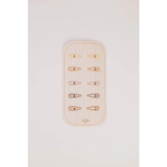 Glitzer Mini Haarklammern aus Gold und Silber auf Holzteller