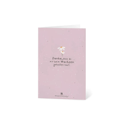 Eine zarte rosa karte danke dass du mir beim wachsen geholfen hast mit weißer gänseblümchenillustration ideal für ökologische baby- & kinderprodukte