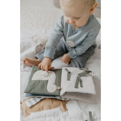 Knisterbuch dog aus weichem salbeigrünem und weißem stoff mit gestickter entenapplikation, nachhaltig und ökologisch ideal als geschenk für neugeborene