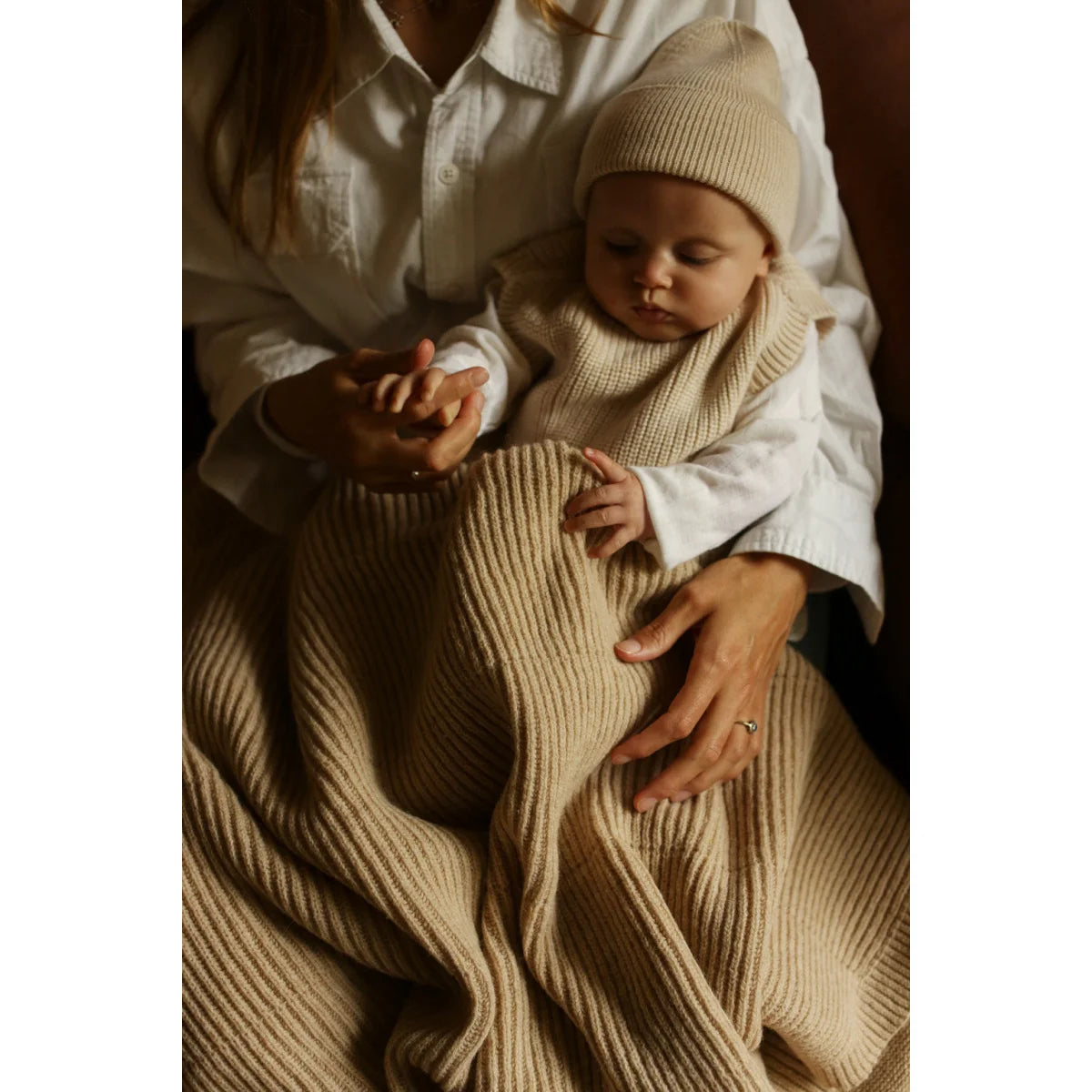 Schlafendes Baby in beiger Merino Strickdecke Gaston gewickelt