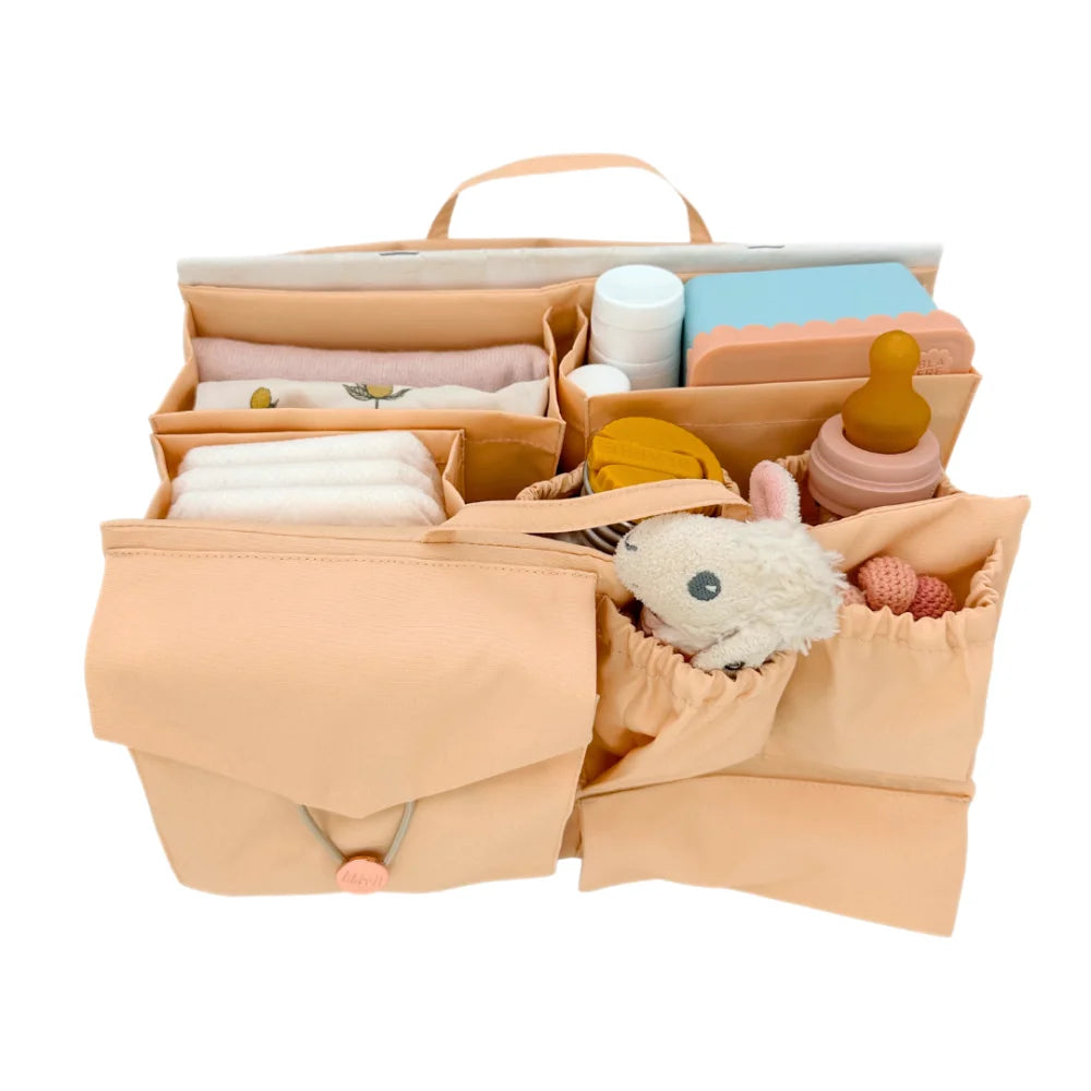 Beige Diaper Bag Organizer filled with essential baby items for parents