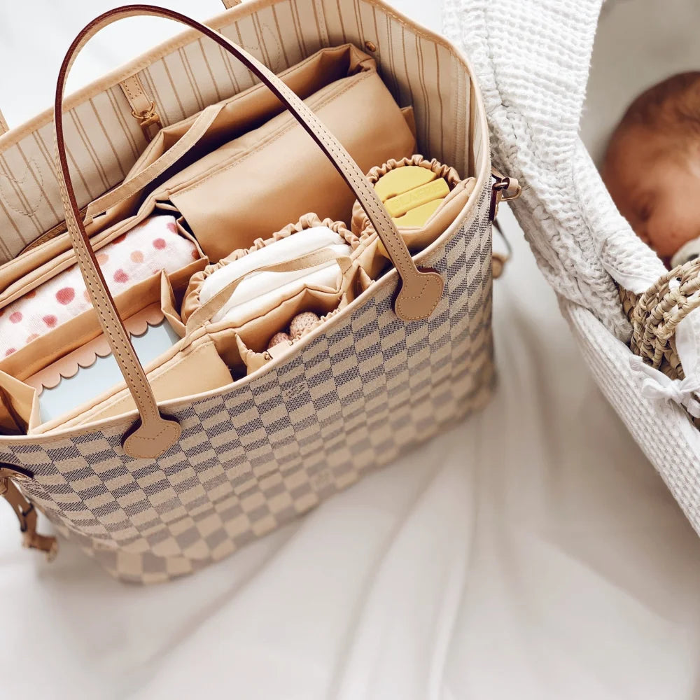 Beige Mom Bag Organizer filled with baby essentials and accessories in a woven tote