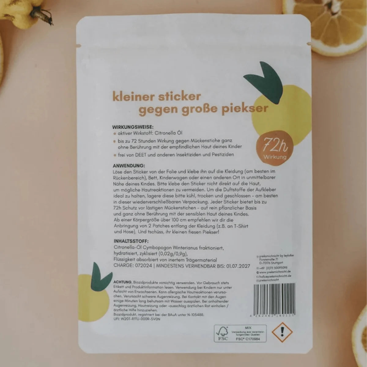 Weißes mückenschutz ocean child edition paket mit oranger schrift gelber zitronenillustration rückseite mit anleitung