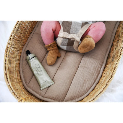 Warenkorb mit Babybekleidung und Lotion Röhrchen für Nappy Cream