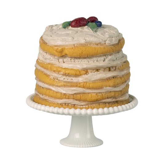 Partytorte mit tortenständer off white mit mehrschichtiger gelber torte und bunten obsttoppings ideal als geschenk für neugeborene