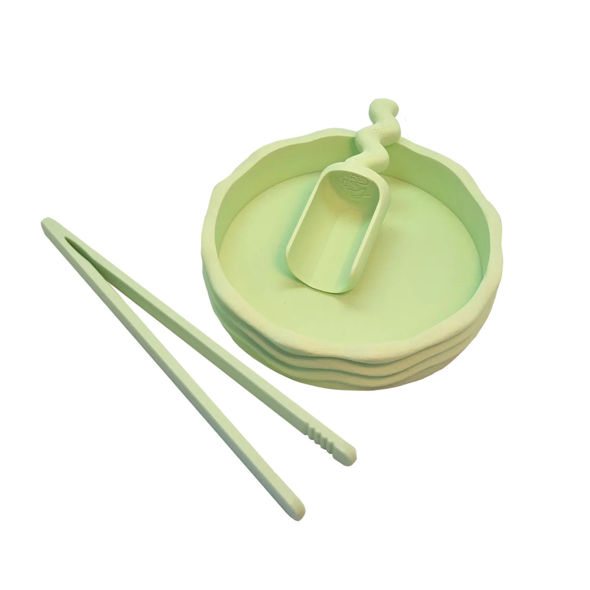 Pastellgrünes silikonmelonen-serviertablett pinzette mit integriertem löffel und passenden zangen für ökologische baby- & kinderprodukte