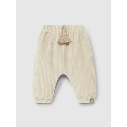 Cremefarbene, gerippte Babyhosen mit elastischem Bund und dekorativen Quasten