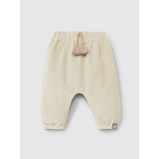 Cremefarbene, gerippte Babyhosen mit elastischem Bund und dekorativen Quasten