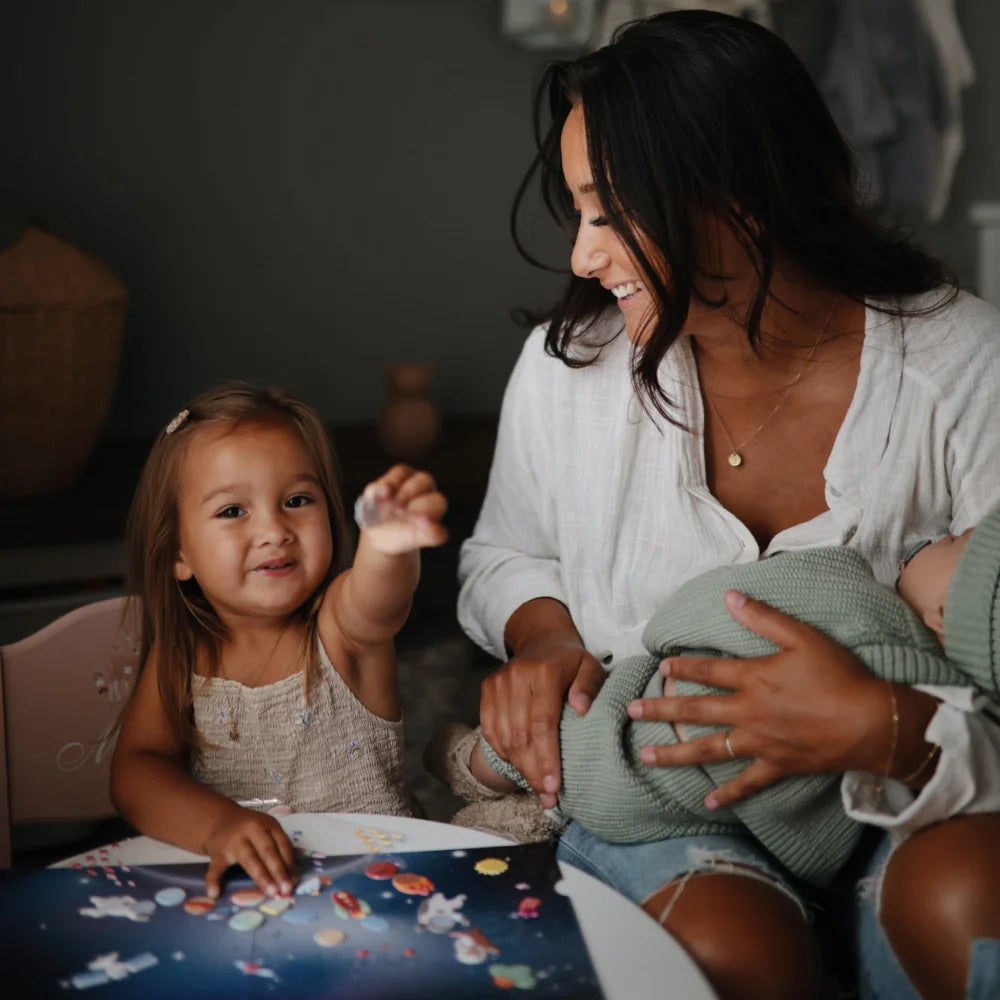 Mutter mit zwei Kindern beim Spielen mit Raumthemen wiederverwendbaren Aufkleberset