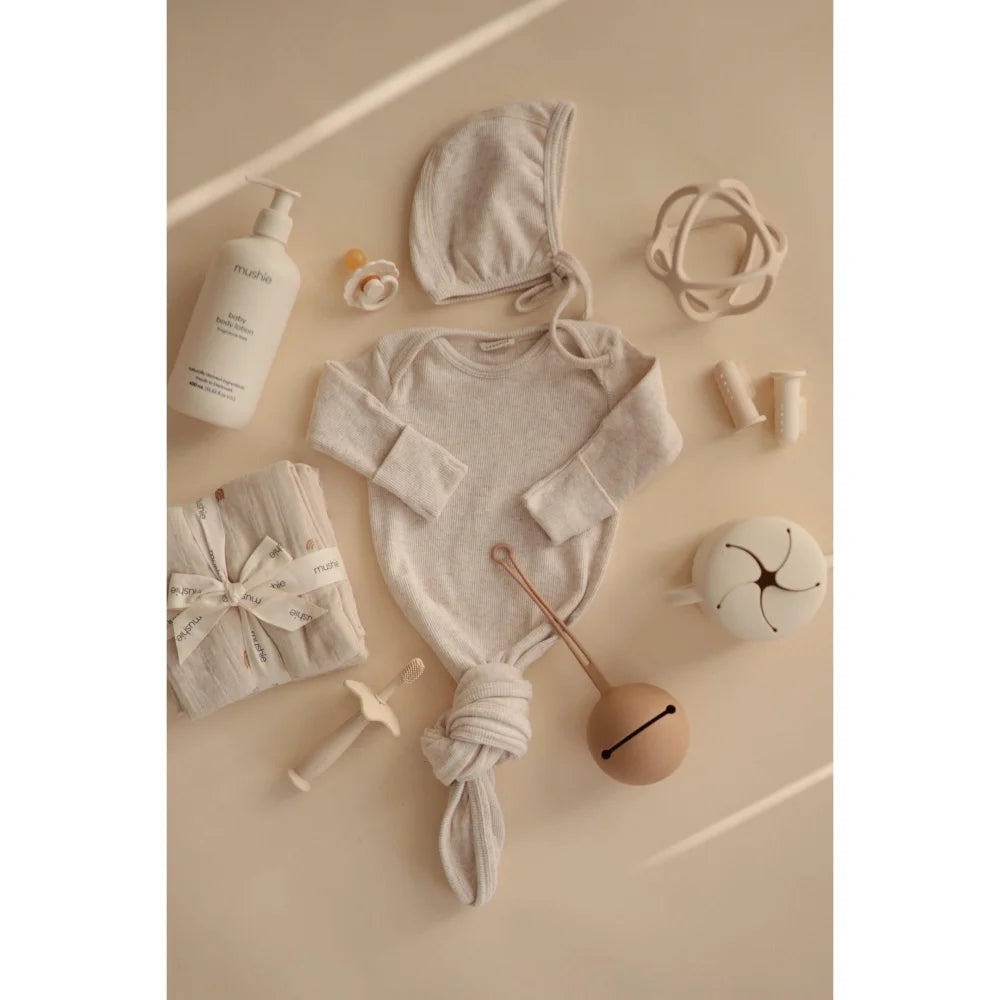 Ribbed Bonnet in Beige Melange with Baby Bodysuit and Accessories Flat Lay