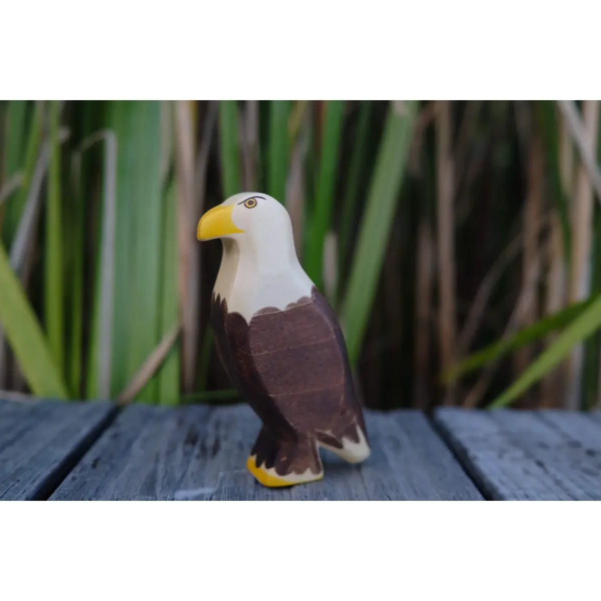 Holzgeschnitzte Seeadler-Figur mit weißem Kopf, braunem Körper, gelbem Schnabel und Krallen