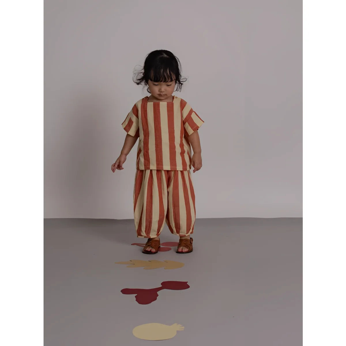 Kind trägt Square Neck T-Shirt Tomato Stripes, orangefarbene Streifen