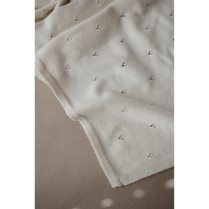 Weißer Stoff mit zartem floralen Stickmuster der Strickdecke Pointelle Ivory