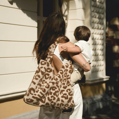 Leopard print Tote Bag carried by a person with a child, showcasing Teddy Mom Bag Ecru Leopard