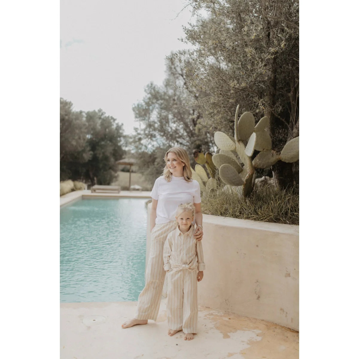 Frau und Kind barfuß am Pool in passenden Leinen-Optik Beige Streifen Hosen