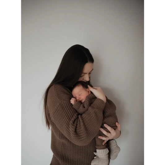 Mutter hält neugeborenes Baby in braunen Strickoutfits, passend zum Women Chunky Knit Sweater